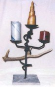 Candle sculpture featuring marble, wood and wrought iron